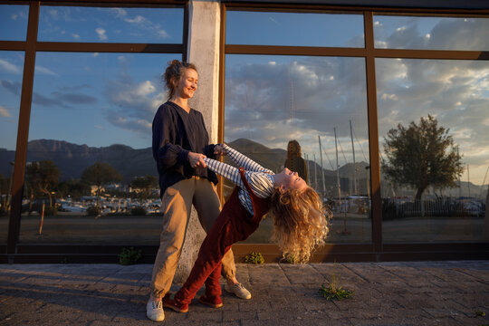 Mother fooling around with daughter on street