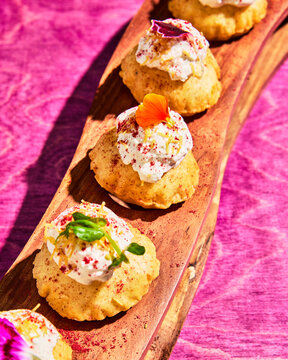 Mini Bundt Cakes on Wooden Board With Whipped Cream & Lemon Zest