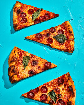 Offset Pepperoni Pizza Slices on Vibrant Blue Background