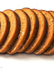 Tasty sliced rye bread loaf with nut pieces on a white background. Healthy food. High grain product. Bakery item.