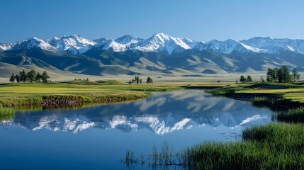 Naklejka premium Snowy peaks reflected in a lake, beside a grassy golf course fairway