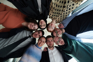 A diverse group of business professionals standing together in a powerful, united pose, captured...