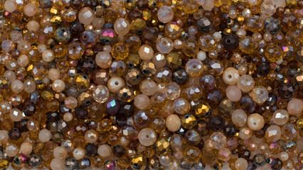 Close up of brown and gold crystal beads matte and transparent flat lay background