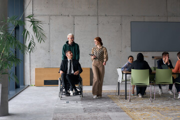 A diverse team of business colleagues, including a director in a wheelchair, engages in a collaborative discussion as they move together through a modern office space