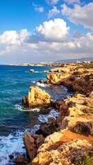 Fototapeta premium Coastal cliffs meet turquoise water under a bright sky