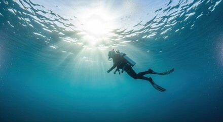 Underwater diver silhouette, sunbeams