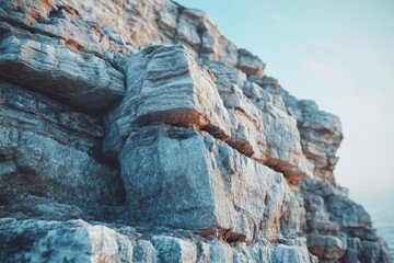 Fototapeta premium Close-up view of layered rock formations on a cliff face, near the ocean.