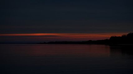 Dark red sunset over water
