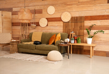Interior of living room with glucophone on sofa and tables