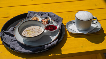 Reserved breakfast at a cafe. A plate of porridge on a table in a street cafe. 