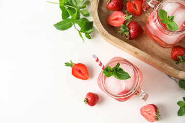 Glasses of tasty cold cocktail with strawberry on white background, closeup