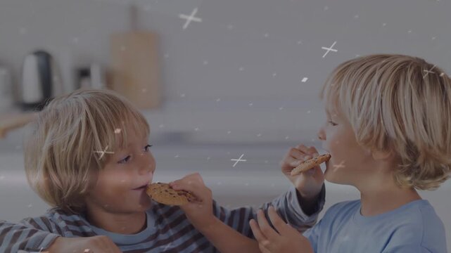food ad showing brothers breaking cookies and feeding each other in kitchen with cross graphics