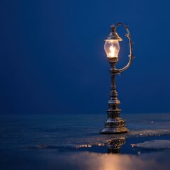 Obraz premium Miniature Victorian Lamp Post Illuminates Dark, Reflective Surface with Warm Glow.