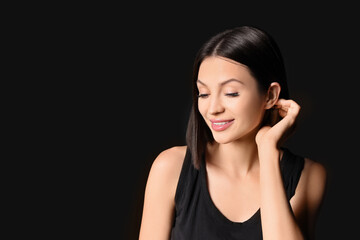 Fototapeta premium Beautiful young woman with short hair on dark background