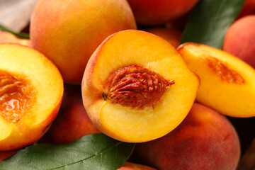 Texture of sweet ripe peaches with leaves as background