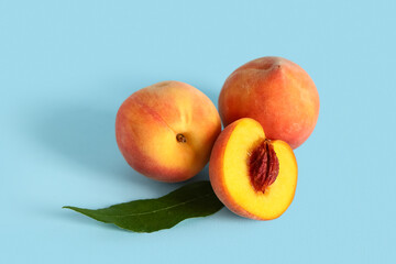 Sweet ripe peaches on blue background