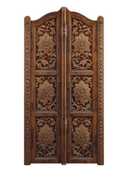 Antique, carved wooden door with a gold handle and intricate texture