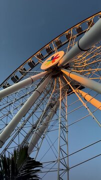 Giant Ferris Wheel Spinning at Night with Colorful Lights