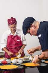 Two generations preparing the filling for traditional Venezuelan hallacas