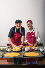 Multigenerational chefs preparing traditional venezuelan dish, hallacas