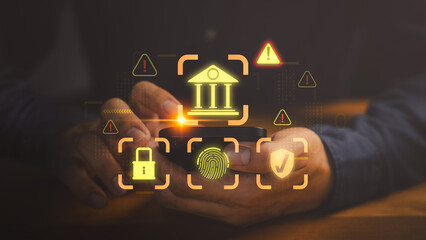 Hands holding smartphone with glowing icon of bank, fingerprint, lock, shield and warning signs,...