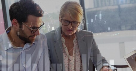 Leaning professionals in blazers reviewing market charts on laptop at desk by window, chart overlay