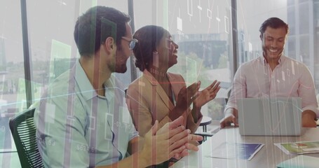 Applauding three professionals in suits watching laptop presentation in meeting room, with charts