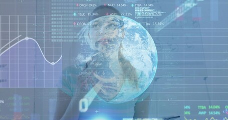 Monitoring financial analyst studying data charts in control room with digital globe and tickers