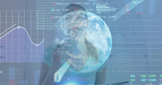 Data analyst wearing teal top tapping stylus on holographic charts in office, with globe hologram