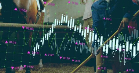 Mother in denim khaki outfit holding pitchfork by horse in stable, with finance overlay, copy space