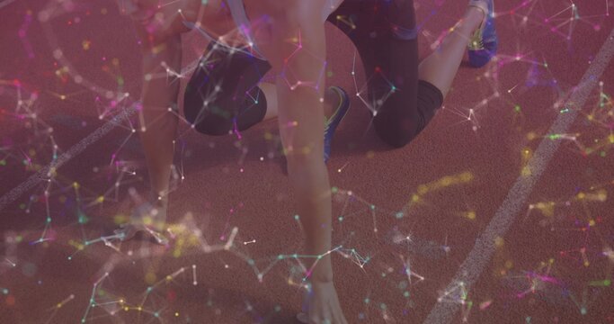 Crouching female athlete holding starting stance on running track wearing shoes, with node overlay - Powered by Adobe