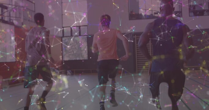 Sprinting trio teammates running down basketball court in gymnasium, showing network overlay