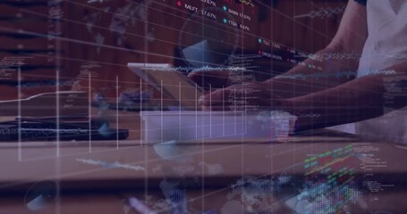 Craftsman tapping tablet activating grid while stock tickers streaming charts tracking market dip - Powered by Adobe