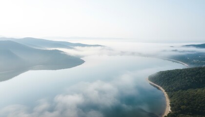 Obraz premium Serene Coastal Landscape: Misty Morning Bay with Tranquil Waters