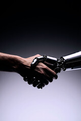Naklejka premium Human and robotic hands shaking, symbolizing the future of AI integration and partnership