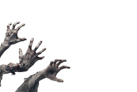 Zombie hands reaching from black background