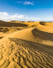 Golden desert dunes under a vibrant sky