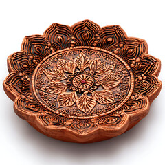 Engraved clay Diya with floral mandala pattern on white background. 