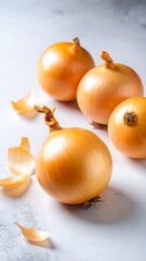 Fresh yellow onions on a light surface
