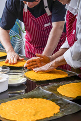 Generations collaborate on making hallaca dough