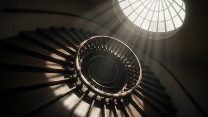 Spiral staircase with wooden steps and railing illuminated by light from a skylight above - Powered by Adobe