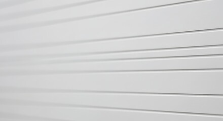 A close-up, abstract view of a white corrugated metal surface with horizontal lines receding into the distance.