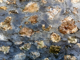 Seamless texture brown stone wall. Old stone masonry background texture. Close up of a stone wall texture
