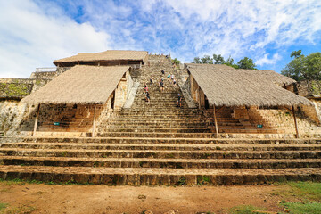 Tourists clamber up the Steep staircase, 32 m high,leading to the top of the Acropolis Pyramid with the tomb of Ukit Kan Lek Tok, of the Mayan city of Ek Balam,near Valladolid,Yucatan,Mexico