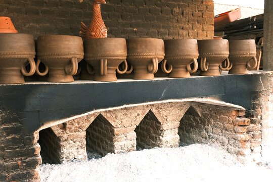 Big clay pots, water dispenser, kendi, guci or pottery craft in the morning. Pottery craft for indoor and outdoor decoration. Handmade, Indonesian product. Gerabah