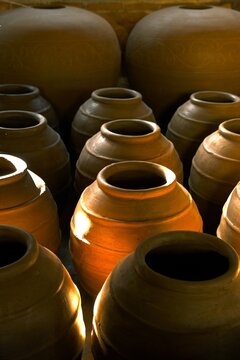 Big clay pots, water dispenser, kendi, guci, gentong air or pottery craft in the morning. Water dispenser, kendi, guci, gentong air or decoration for indoor or outdoor. Handmade, Indonesian product.