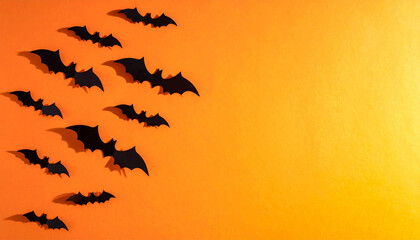 Enchanting Halloween Silhouette: Silhouette of bats gracefully take flight against a gradient orange backdrop, casting an eerie charm. The composition evokes Halloween atmosphere.