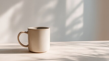 Single ceramic coffee mug mockup on smooth white desk surface, bathed in natural sunlight from left, wide empty background with blank copy space for product presentation