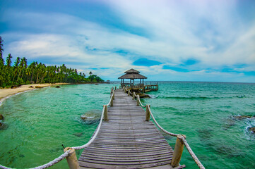 Fototapeta premium tropical beach with wooden bridge