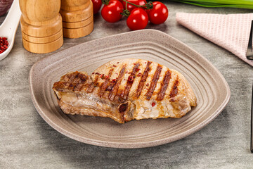 Grilled pork loin steak with bone